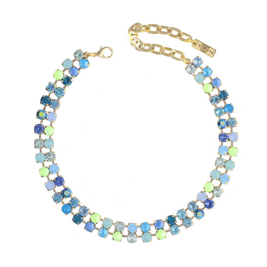 Multicolored beaded necklace with gold chain on a white background