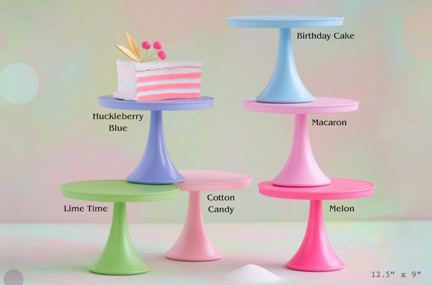 Four pastel-colored mini cake stands in different shades labeled 'Lime Time,' 'Cotton Candy,' 'Pink,' and 'Macaron,' with one stand holding a pink-and-white striped cake slice. Text labels identify each color variant, and the image has a soft pastel background with decorative bokeh.