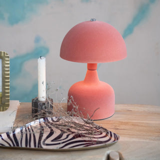 Pink table lamp on a wooden surface with decorative elements zebra tray