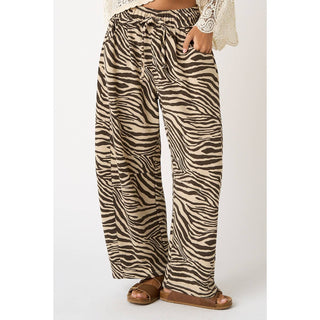 Zebra print pants worn by a person on a white background