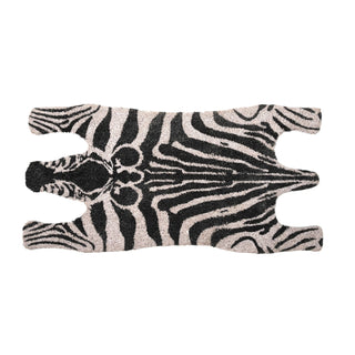 A zebra-patterned rug with black and off-white stripes, shown flat against a solid white background.