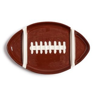 Football-shaped plate with brown and white design on a white background
