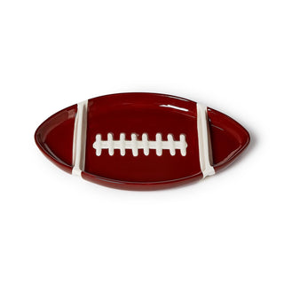 Football-shaped plate with white laces on a white background