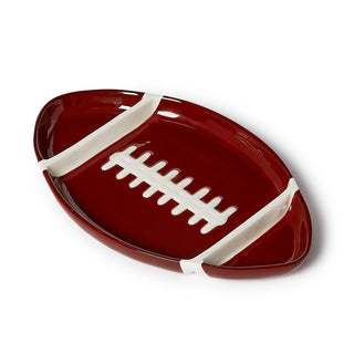 Football-shaped plate with white laces on a white background