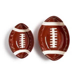 Two football-shaped ceramic plates on a white background