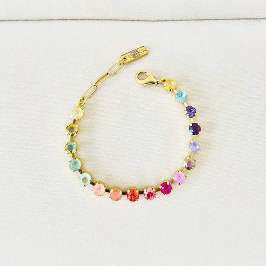 Multicolored beaded bracelet with gold clasp on a light gray background