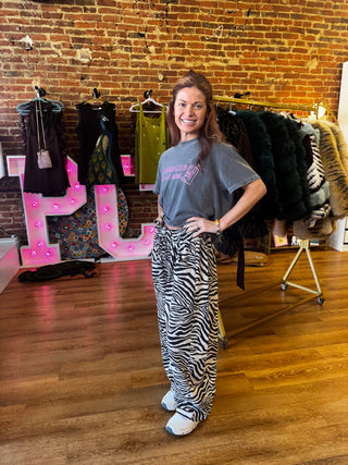 Woman wearing black and cream zebra print barrel large sweatpants 