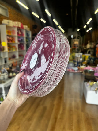 A pack of 50 round decorative paper plates featuring a vintage-style illustration in white on a maroon background. The design includes a seated bulldog, flowers, butterflies, birds, and ornamental border motifs.