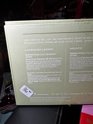 The back of a square product box in a pale sage green color, featuring 'Directions for Use' and nutrition facts for Lavender Lemon and Mojito flavors. A white handwritten price sticker with '3.