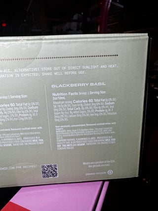 The back of a Blackberry Basil cocktail mixer box, showing product details, nutrition facts, and a QR code on a dark background.