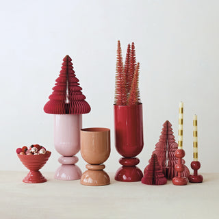 Decorative items including vases, trees, and candle holders in red and pink on a white background