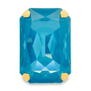 Blue gemstone with gold prongs on a white background
