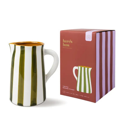 Striped ceramic pitcher with packaging on a white background