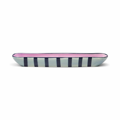 Rectangular ceramic tray with pink interior and blue and white striped exterior on a white background