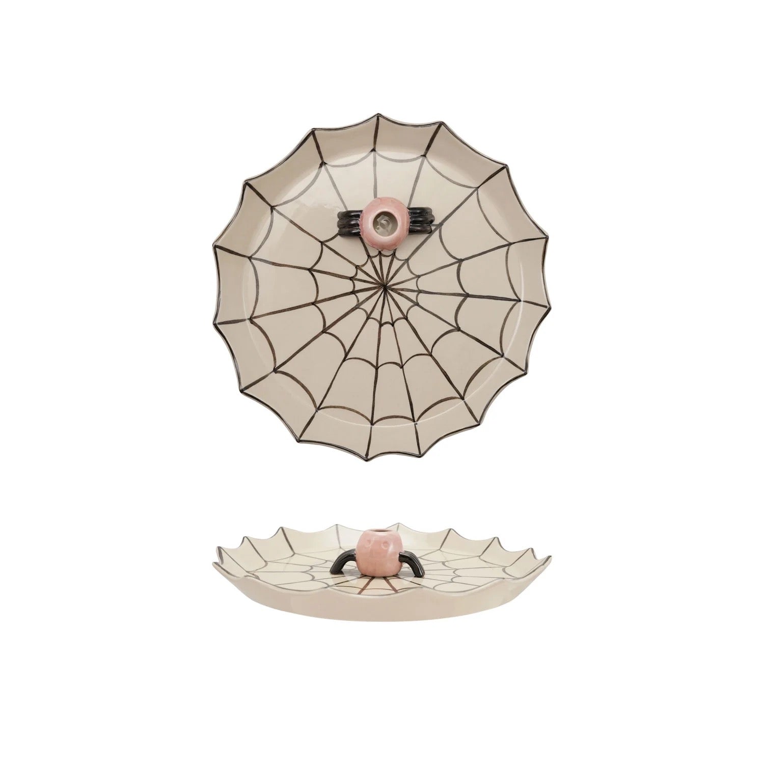 A ceramic spiderweb-themed dish with a scalloped rim, featuring a top-down view of a spiderweb pattern with a pink center and a bottom view showing a small raised spider face at the hub.
