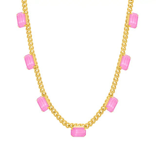 A gold chain necklace featuring multiple rectangular pink gemstone accents spaced along the chain, shown against a plain white background.