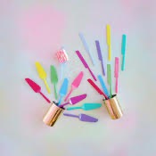 Colorful cake servers and knives in various vibrant styles displayed in a playful arrangement.