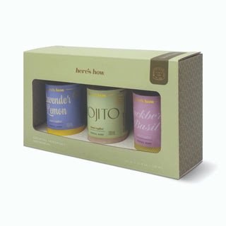 A boxed cocktail mixer set from Here's How, containing three small bottles visible through a window in a pale sage green package. The bottles are lavender lemon, ojito, and blackberry basil, with blue, yellow, and pink labels respectively.