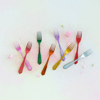Colorful forks arranged on a light background
