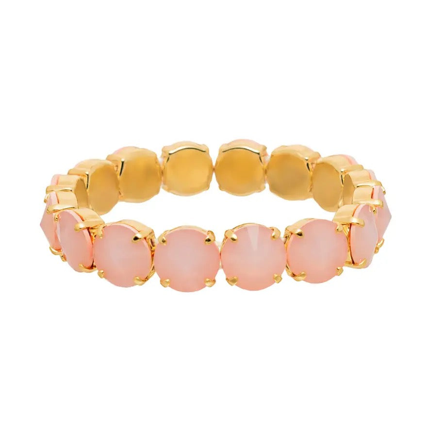 Gold and pink beaded bracelet on a white background
