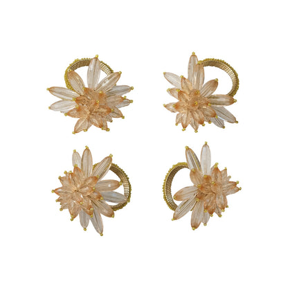 Set of four floral earrings with gold accents on a white background