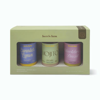Here's How Cocktail Mixer Set Botanicals gift box containing three botanical-infused mixers: Lavender Lemon, Mojito, and Blackberry Basil, in a light sage green box with a clear window.
