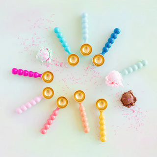 Colorful ice cream scoops with sprinkles on a light background