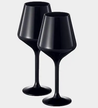Two black wine glasses on a white background