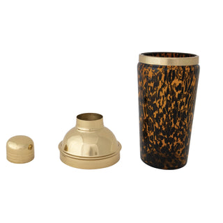Cylindrical container with gold lid and leopard print design on a white background