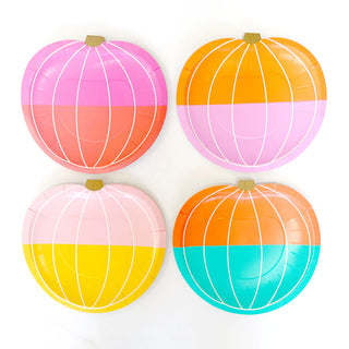 Four colorful paper plates shaped like pumpkins on a white background
